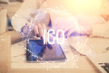 Double exposure of blockchain business sketch hologram and woman holding and using a mobile device.