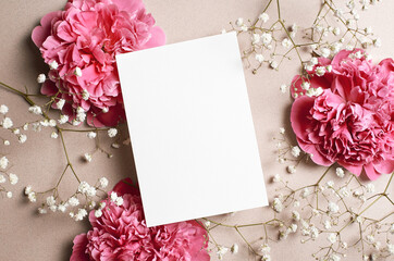 Wedding invitation card mockup with pink peony and gypsophila flowers