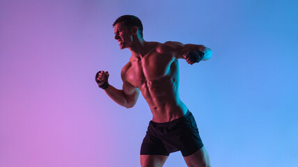Boxing concept. Sportsman muay thai boxer fighting in gloves. Isolated on neon background. Copy Space.