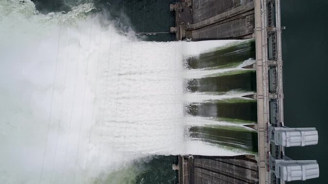 Aerial top down view of water discharge at hydroelectric power plant of Krasnoyarsk city, Siberia, Russia