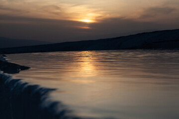 Sunset reflection on travertine in close-up view, Pamukkale, Turkey