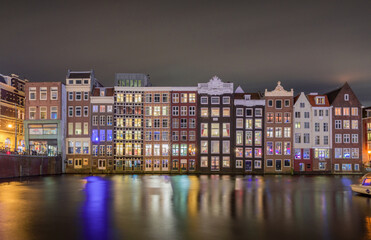 Amsterdam buildings at dusk with water canals and reflections, Netherlands