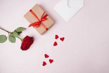 gift box, rose and valentines on a light background.