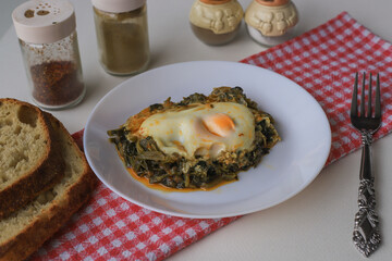 Healthy spinach omelet. Eggs with spinach on a plate.
