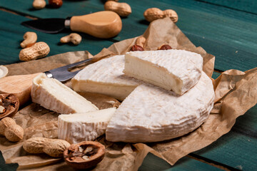 White cheese brie or camembert. The concept of oriental cuisine. National Italian French Gourmet appetizer cheese and nuts