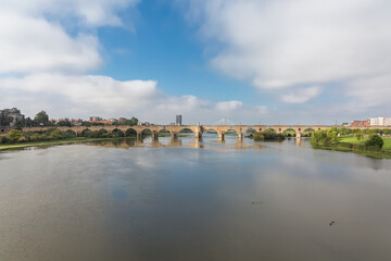 Naklejka premium Amazing morning view at the Guadiana river and Palmas bridge, Guadiana Park river on banks, Badajoz downtown city, Spain