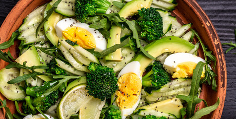 Ketogenic, paleo diet lunch bowl with avocado, cucumber, broccoli and egg. Healthy organic vegan salad. Delicious breakfast or snack, Clean eating, dieting, vegan food concept. top view