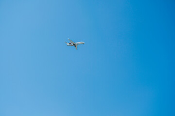 Airplane flying in the blue sky. Travel and flight concept.