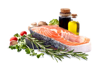 Salmon fish on the white background with fresh  vegetables  and spices.  Salmon steak isolated.