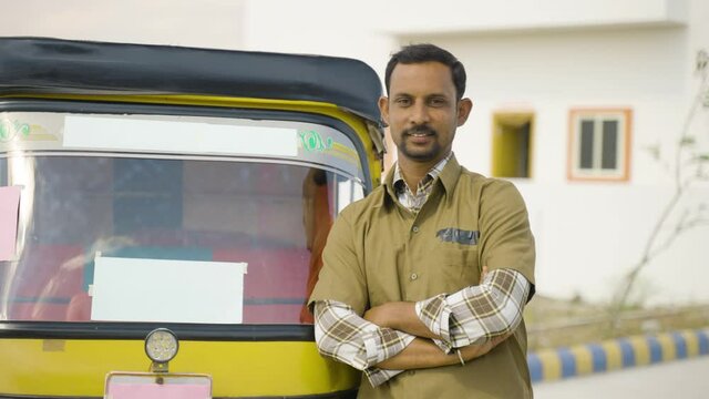 Happy confident smiling auto driver with crossed arms standing by looking at camera - concept of confident, self employed and positive emotion.