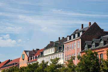 Obraz premium Copenhagen, Denmark-Christianshavn canal, colorful facades of old houses. King Christian's Harbour is a neighbourhood in Copenhagen. Real estate investment. Rent an apartment. Expensive housing. 