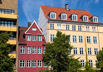 Fototapeta premium Copenhagen, Denmark-Christianshavn canal, colorful facades of old houses. King Christian's Harbour is a neighbourhood in Copenhagen. Real estate investment. Rent an apartment. Expensive housing. 