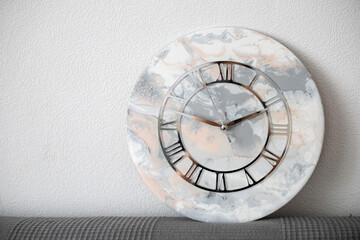 Handmade epoxy wall clock in light colors. Hobby.