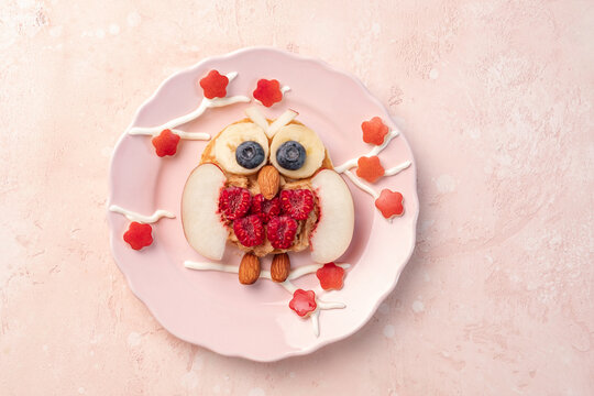 Owl pancakes with fruits for kids breakfast. Spring and flowers