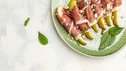 Appetizer with pear, blue cheese and prosciutto ham, Healthy fats, clean eating for weight loss, Long banner format. top view