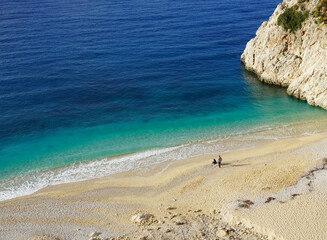 beach with yellow sand and blue sea on a sunny day