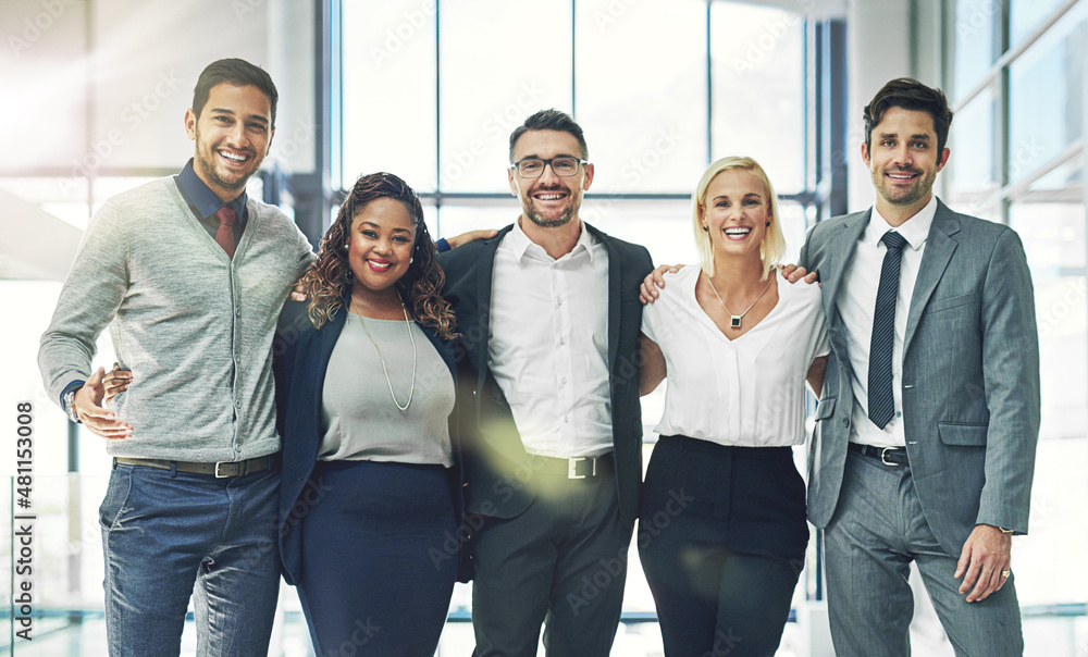 Poster our team knows no limits. portrait of a diverse group of smiling coworkers standing arm in arm in an