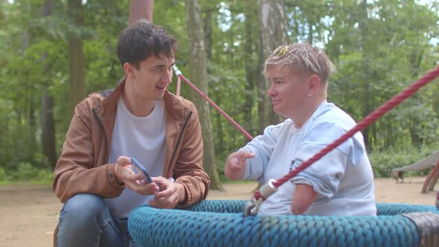 A social worker communicates with a disabled person. Congenital amputations. Amelia is absence of a limb, hemimelia is absence of the forearm or hand.