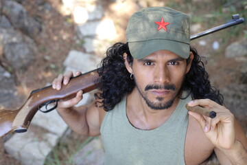 Guerrilla fighter with weapon and cigar
