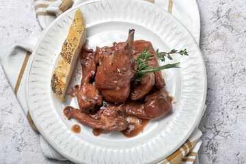 Traditional rabbit meat stew with red wine sauce