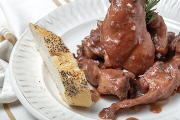 Traditional rabbit meat stew with red wine sauce
