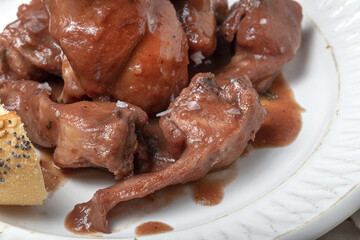 Traditional rabbit meat stew with red wine sauce