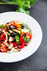fresh vegetable salad tomato, cucumber, pepper, onion, black olives pitted healthy meal food snack on the table copy space food background rustic top view keto or paleo diet