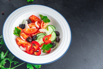 fresh vegetable salad tomato, cucumber, pepper, onion, black olives pitted healthy meal food snack on the table copy space food background rustic top view keto or paleo diet