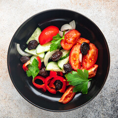 fresh vegetable salad tomato, cucumber, pepper, onion, black olives pitted healthy meal food snack on the table copy space food background rustic top view keto or paleo diet