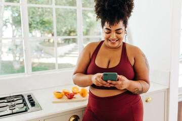 Plus size woman texting on smart phone