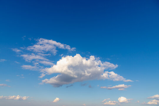 Beautiful white fluffy cloud floating in blue sky in sunny day, Cumulus are clouds which have flat bases and are often described as puffy, Horizon nature background with free copy space.