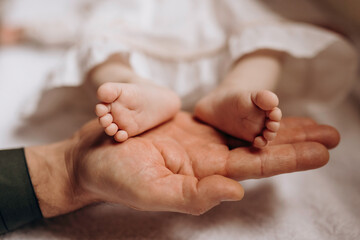 Obraz na płótnie Canvas Newborn feet.Father holding in hand little baby feet