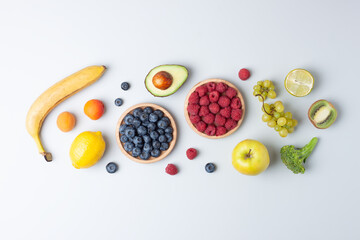 Fresh fruits and vegetables on grey background. Healthy eating concept. Flat lay, composition.