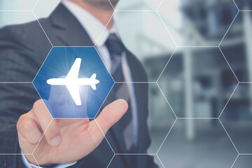 飛行機のボタンを押すビジネスマン Businessman touching airplane screen button 