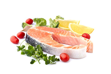 Salmon fish on the white background with fresh  vegetables  and lemon.  Salmon steak isolated.