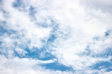 Bright blue sky with coming clouds. Cloudy weather. The weather changes to bad.  Horizontal photo. Abstract natural background.