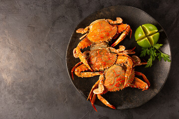 Dish of cooked crabs on the table. © WS Studio