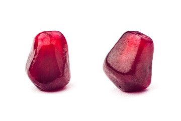 Garnet fruit seeds isolated on white background macro shot. Two grains of pomegranate closeup. Garnet pulp. Tropical fruit  part