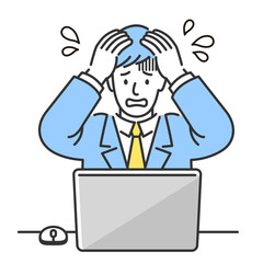 ノートパソコンの前に座って頭を抱えて焦っている若いビジネスマン。