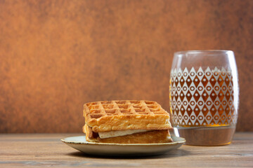 View of waffles and glass of tea