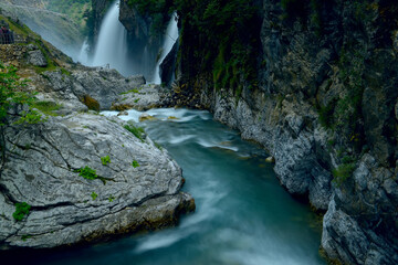 A beautiful cascade of waterfalls and a river among the rocks. Long exposure. Aladaghlar National Park. Kapuzbashi waterfalls. Turkey