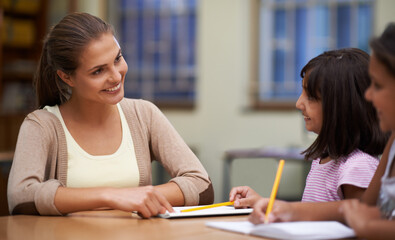 Well done. Shot of a teacher helping her students with their work in the classroom.