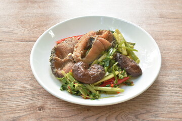 Thai deep fried slice striped snake head fish with ginger and celery on platerice dumpling stuffed mashed pork and bean eat couple fresh lettuce and chili dressing coconut milk on plate