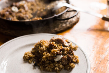 appetizing racy paella montana with mushrooms and pork trotters