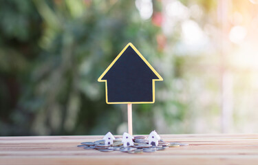 House signs and model houses are placed on coins. indicating the growth of the savings business to buy a house. planning for property, mortgage and real estate investment for saving or  for house.
