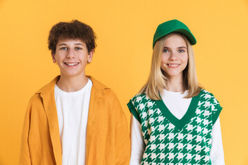 White two teenagers smiling at camera while posing together