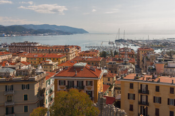 Fototapeta na wymiar city view of houses of La Spezia on coast of Tyrrhenian Sea, Italy on sunny day