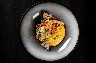 Mashed potatoes with fried oyster mushrooms in bowl