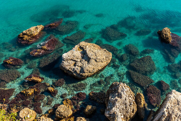 Detail of the sea and rocks on Calahonda beach in the town of Nerja, Andalucia. Spain. Costa del sol in the Mediterranean Sea.