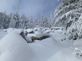 winter Christmas landscape; big stones in the mountains covered with snow